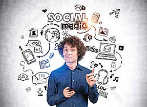 Young man finger point at different social media icons, phone and network