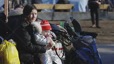 Lviv, Ukraine - March 15, 2022: Mother and her child. Refugees from Ukraine at the railway station. War at Ukraine