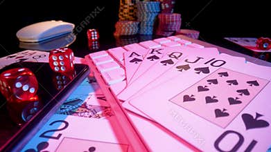 Computer keyboard and Royal Street Flush on black background. Cards, casino chips and dice close up. Concept of gambling