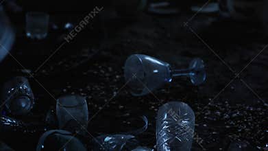 antique glassware scattered on the floor in an abandoned old house in the attic at dusk close-up. Vintage flatware