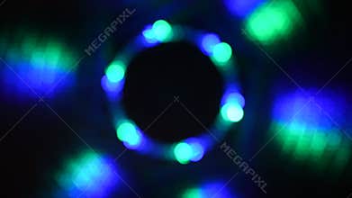Blurry spinning red green blue lights against a black background