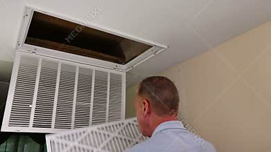 Replacing Dirty Air Filter with a Clean Air Filter in Ceiling Furnace
