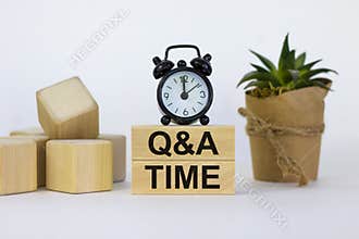 Q and A, questions and answers time symbol. Concept words `Q and A time` on wooden blocks on a beautiful white background. Black