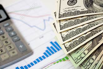 Close-up money against the stock chart