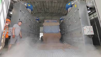 the driver opens the tailgate of the grain truck and the grain is poured into the bunker