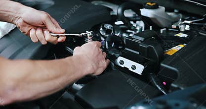 Auto mechanic working with wrench on vehicle engine in car service. maintenance and repair