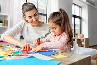 daughter with mother making applique at home