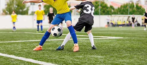 Football Kids Playing Game. Two Players in Opposing Teams in a Duel