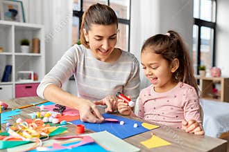 daughter with mother making applique at home