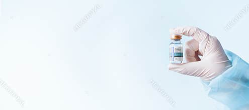 Ampule of covid vaccine on blue back