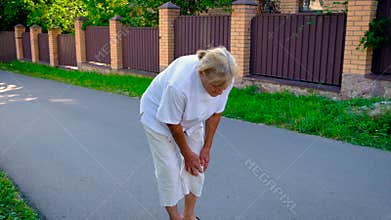 The old woman has a knee pain. Selective focus.