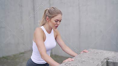 Sportswoman doing push ups near border