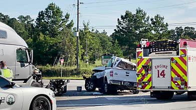 A semi truck collision with a pickup truck back view pan zoom