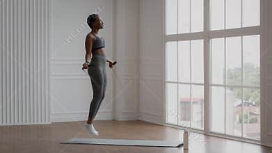Sporty African American Woman Exercising With Jumping Rope At Home