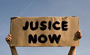 A poster with the words JUSICE NOW in the hands of a young girl against a blue sky