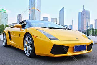 A yellow Lamborghini in guangzhou skyline background