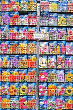 Different variety of flower seeds in colourful packet on display for sale at Amsterdam floating flower market of Bloemenmarkt