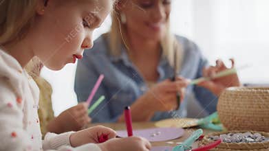 Close up video of mother and daughter during handmade decorations.