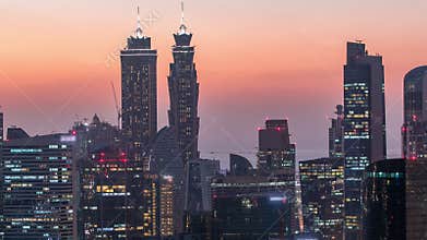 Aerial view of a big modern city day to night timelapse. Business bay, Dubai, United Arab Emirates.