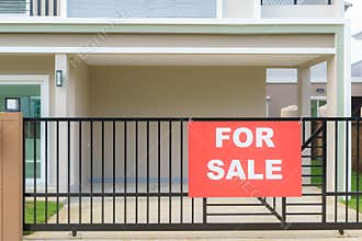 House sale sign hanging on the fence of the house door to announce to interested parties to contact