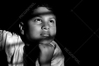 Dramatic look of a child. Portrait of a child. The golden eye looking at the future.