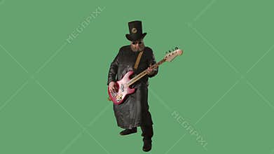 A bearded man in a long leather coat, an Irish style hat and original glasses plays the red guitar. Rock musician plays