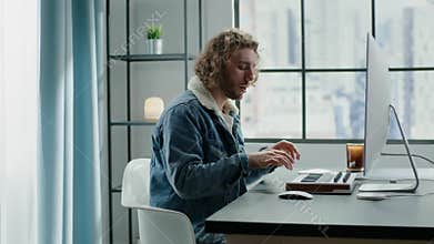 Composer in fur collar denim jacket plays electric piano