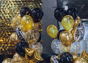 black and gold helium air balloons on white background, celebrate, party.