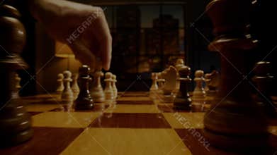 Chessman moves white chess bishop on wooden board squares