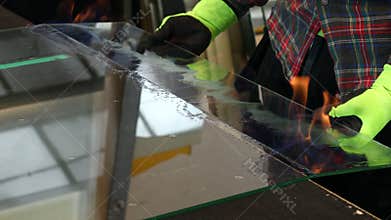 Cutting anti-burglary glass using the traditional method. Burning foil in VSG glass. Glazier cuts specialist glued glass