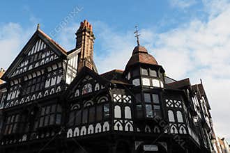 half timbered buildings on the corner of Eastgate and bridge street with stairs leading to the upper rows in Chester