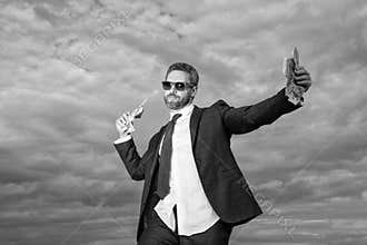 photo of positive billionaire man with money. billionaire man with money on sky background.
