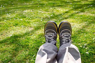 Legs sitting stretched in nature