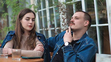 A young couple Denim clothes On a date in a vintage restaurant outside They are talking