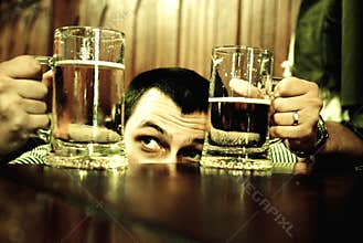 Man comparing beer mugs