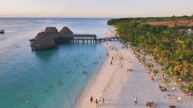Aerial view of beautiful bungalow and sea at sunset in summer