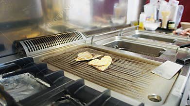 Cooking Swordfish On The Grill Of A Restaurant Kitchen