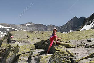 Hiking child climbing in the Alps
