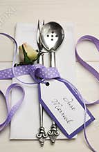 Purple and white shabby chic wedding table setting. Vertical.