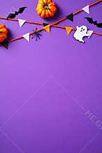 Halloween vertical banner with bunting, ghosts, pumpkins, bats, spiders on purple background. Flat lay, top view, copy space