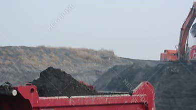 Excavator loading truck