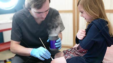 Dermatologist remove of benign tumors with liquid nitrogen for cute preschooler girl