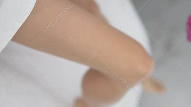 Close-up, applying gel to the leg before laser hair removal.