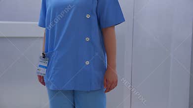 Doctor and nurse walking to elevator while young asian man leave elevator with elderly father sitting on wheelchair.