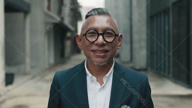 Asian business Man with cheerful expression stands on the city street. People portrait