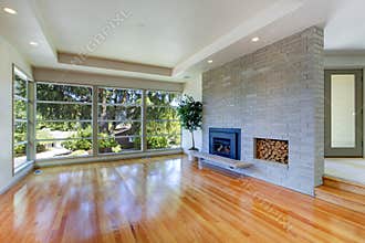 Empty house interior. Living room with glass wall and brick wall