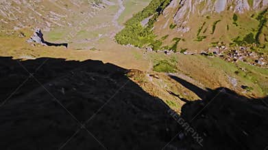 Dive. High-altitude rocky gorge, high-speed descent with an FPV drone. Fall near a cliff. Filmed with a sports FPV drone.