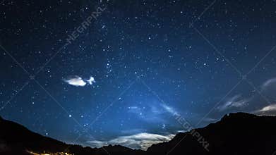 Timelapse stars and moon in mountain night sky. Moonrise