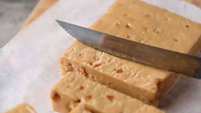 Cutting a Christmas soft almond nougat bar