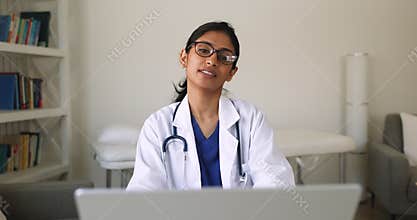 Indian woman therapist or cardiologist working on laptop